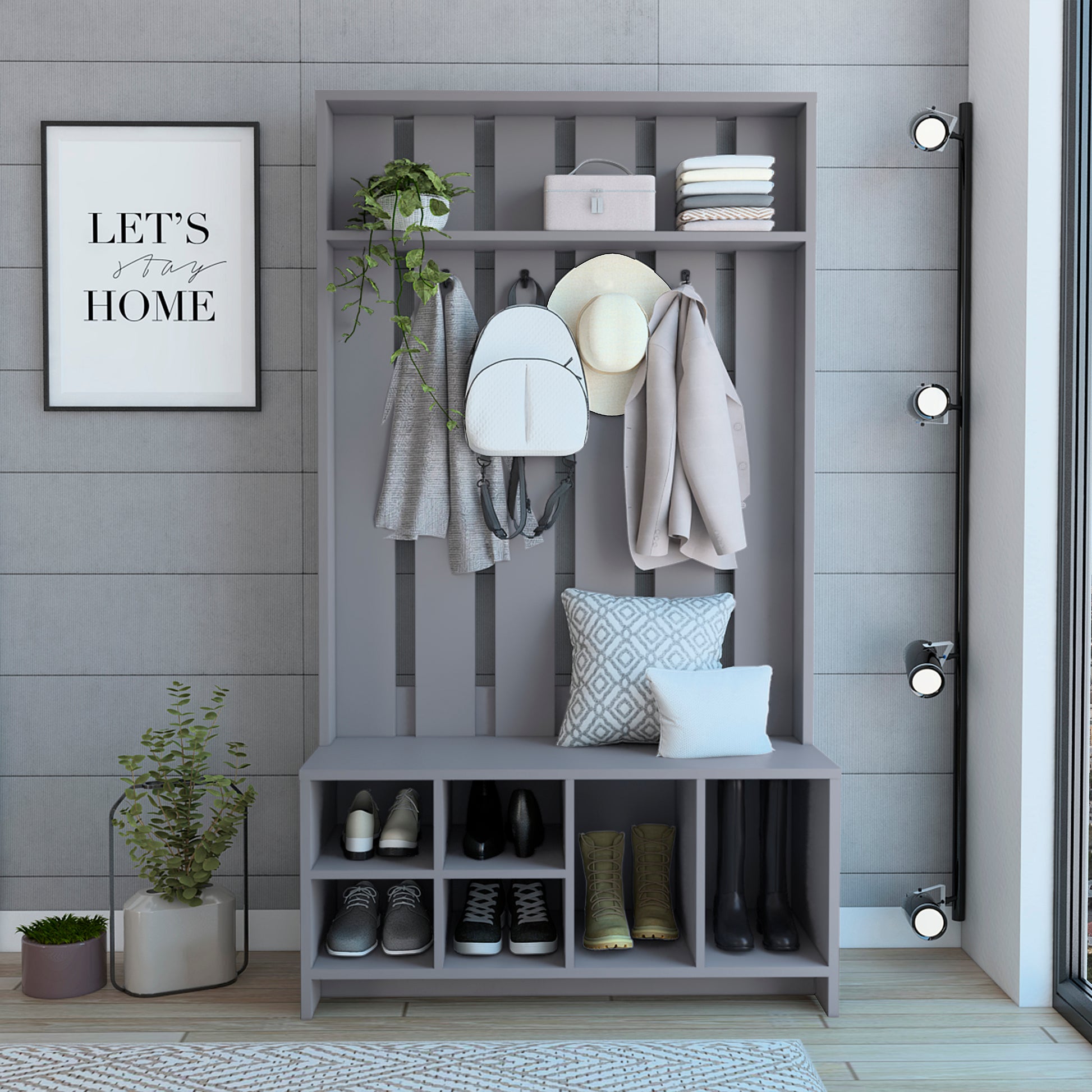 Gray entryway hall tree with shoe storage coat hooks hat shelf and decorative pillows
