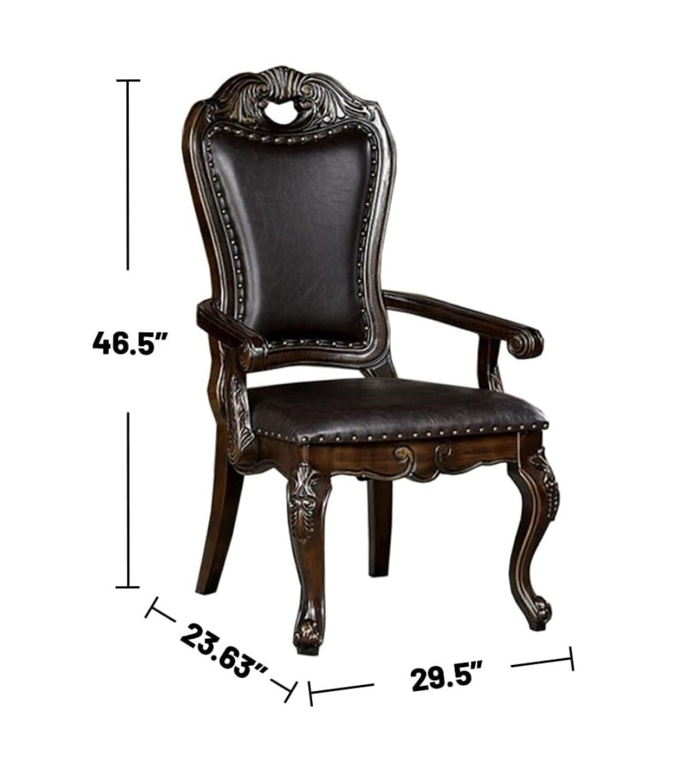 Ornate dark brown leather armchair with carved wooden details and nailhead trim