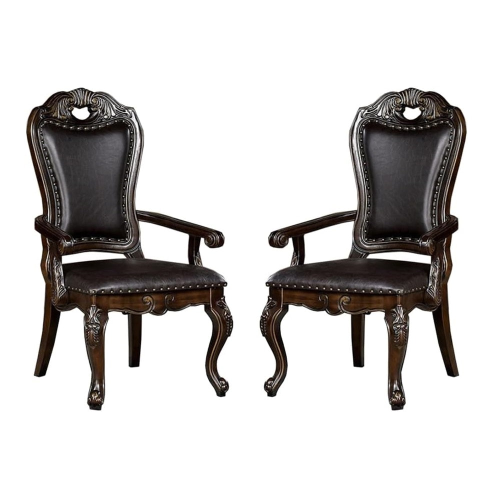Pair of ornate dark brown leather upholstered dining chairs with carved wooden frames