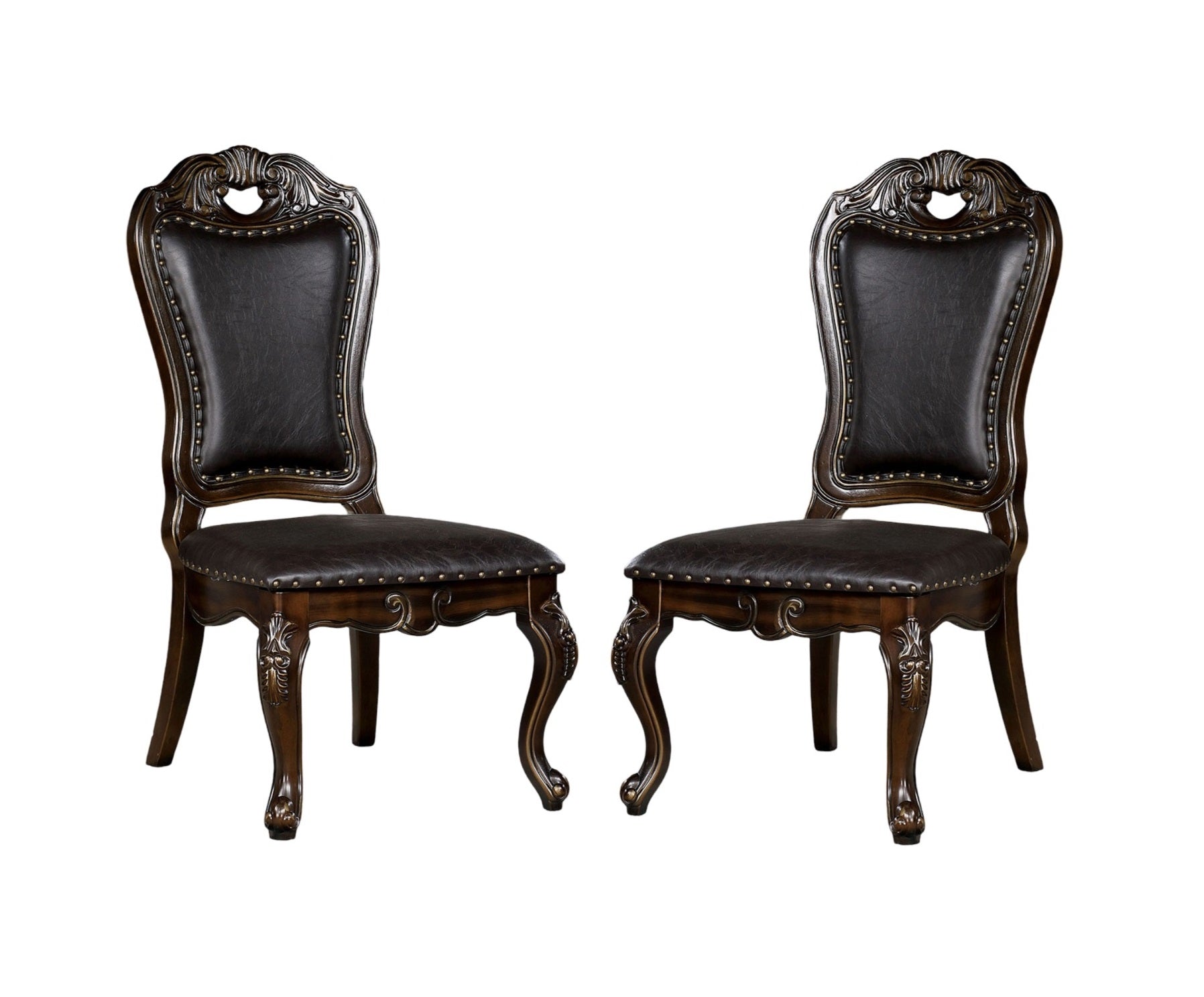 Ornate dark brown dining chairs with tufted faux leather seats and carved wooden legs
