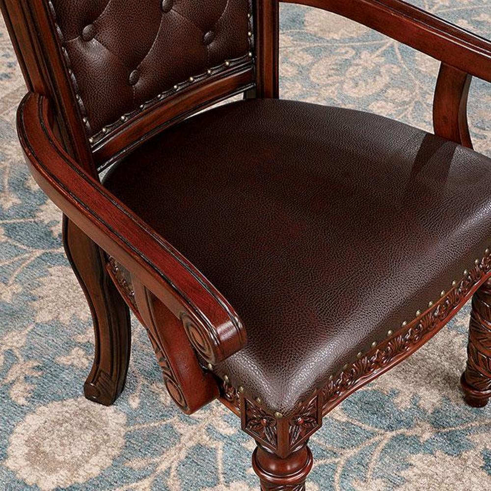 Rich mahogany executive chair with tufted leather seat and detailed carved legs