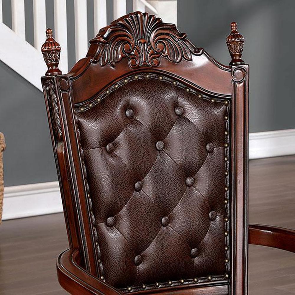 Ornate brown leather tufted armchair with dark wood trim and brass studs