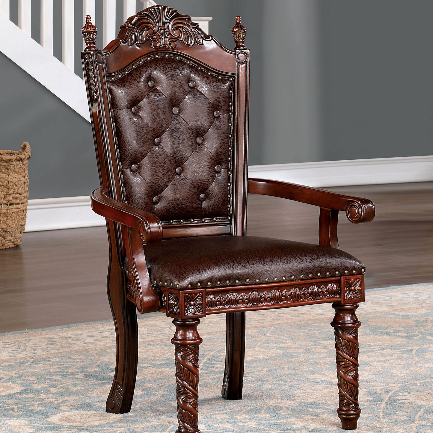 Ornate mahogany executive chair with rich brown tufted leather upholstery and carved detailing