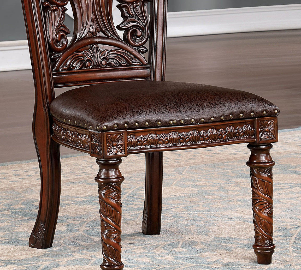 Ornate mahogany dining chair with carved details and dark brown leather seat
