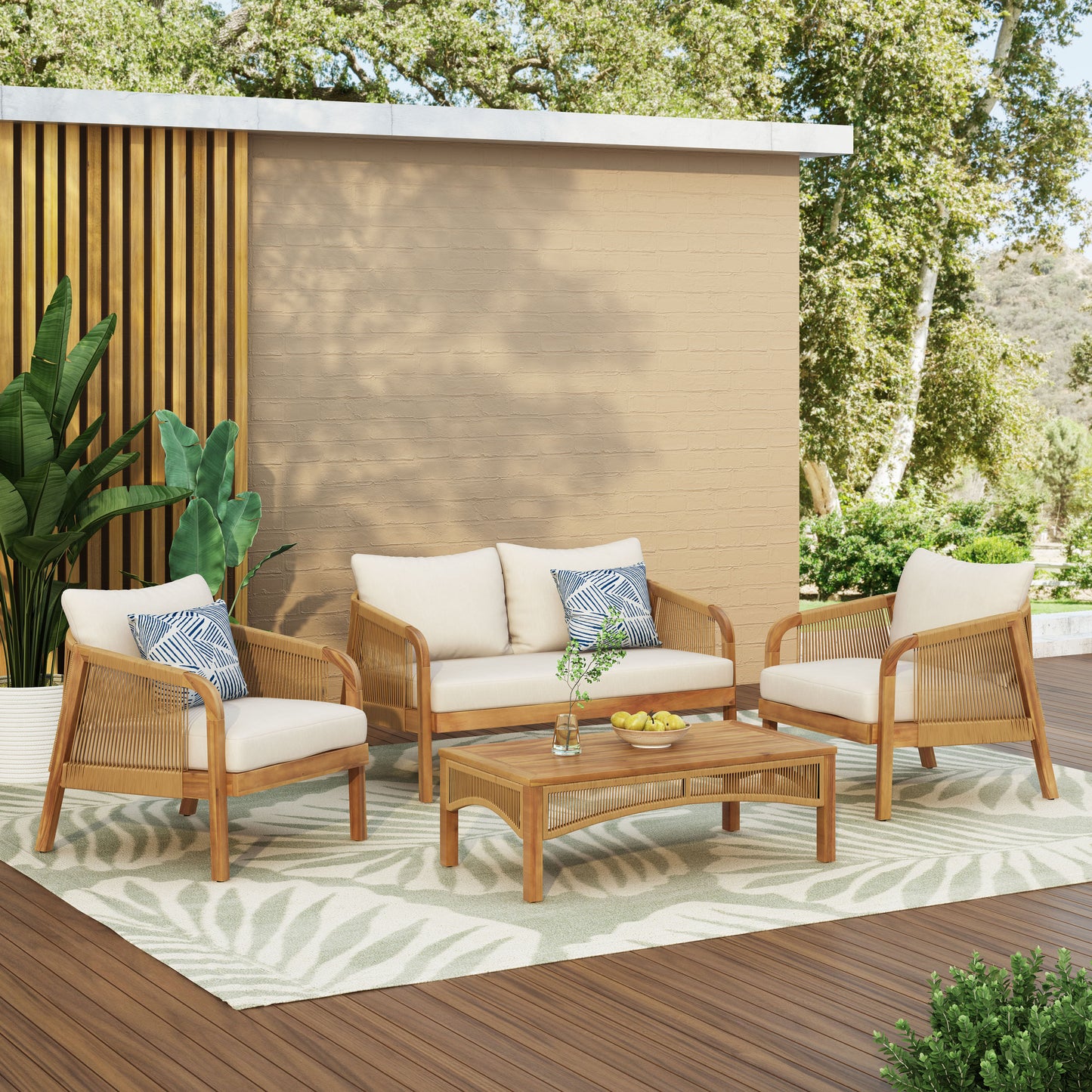 Natural wood outdoor furniture set with cream cushions and geometric pillows