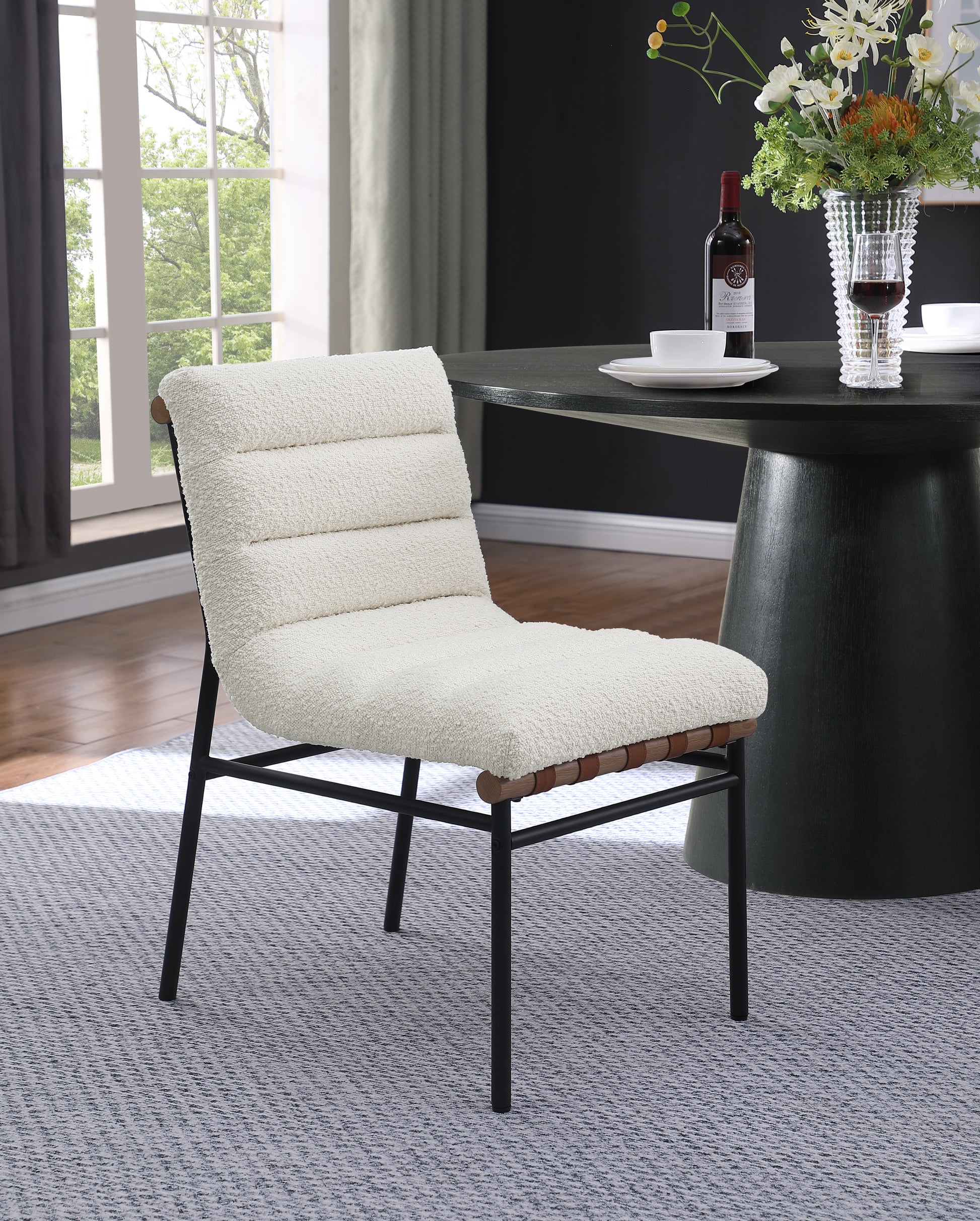 Cream boucl dining chair with black metal frame and wood accents