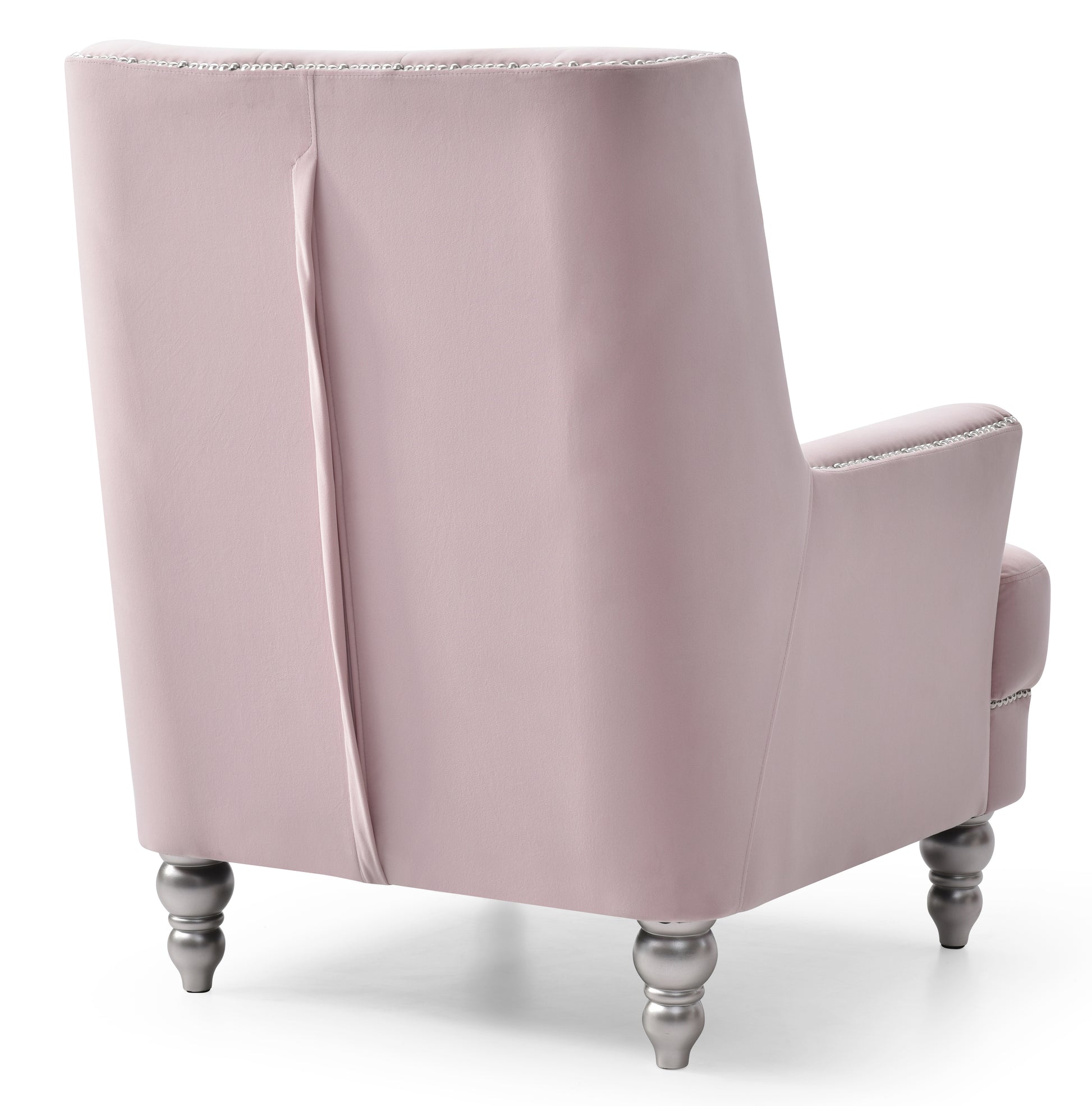 Back view of a plush pink velvet armchair with silver studded trim and decorative silver legs