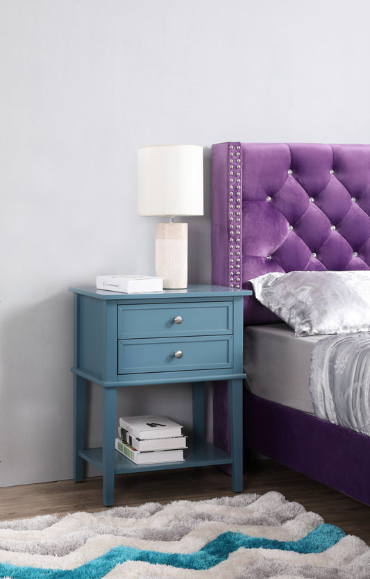 Teal wooden nightstand with two drawers and silver knobs holding a beige table lamp
