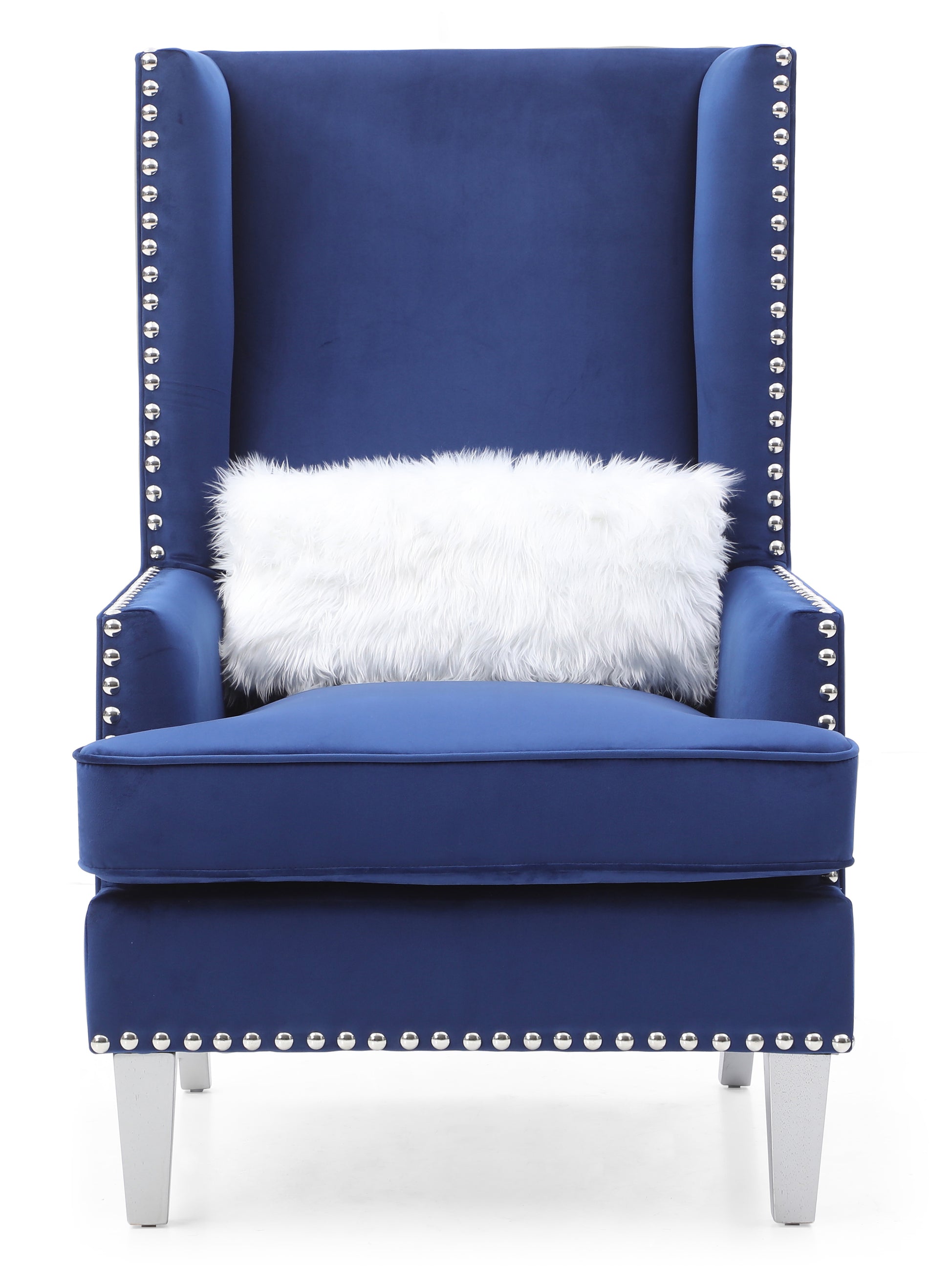 Royal blue velvet wingback chair with silver stud detailing and plush white pillow