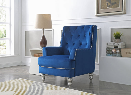 Deep blue velvet accent chair with tufted back and silver nailhead trim