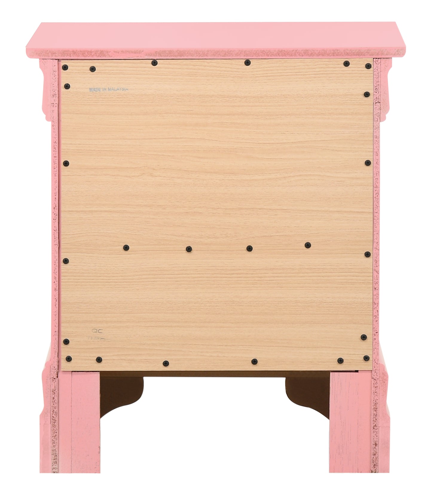 Pink wooden nightstand back panel with visible screws and Made in Malaysia label
