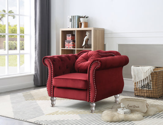 Deep red velvet armchair with silver nailhead trim tufted back and ornate silver legs perfect for a living room
