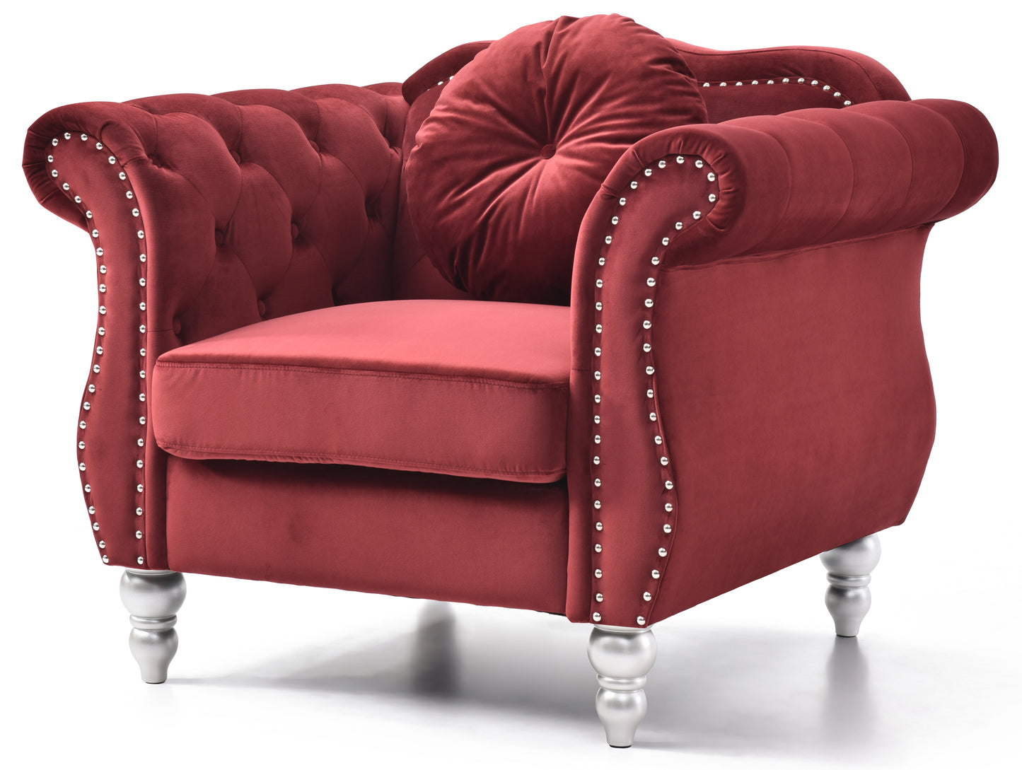 Deep red velvet armchair with tufted back silver stud accents and round accent pillow