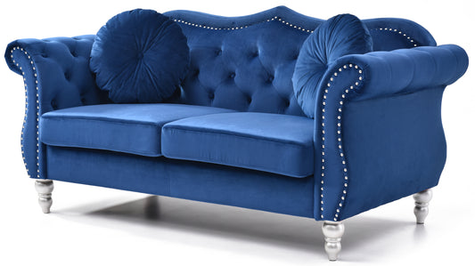 Deep blue velvet sofa with tufted back and silver stud trim