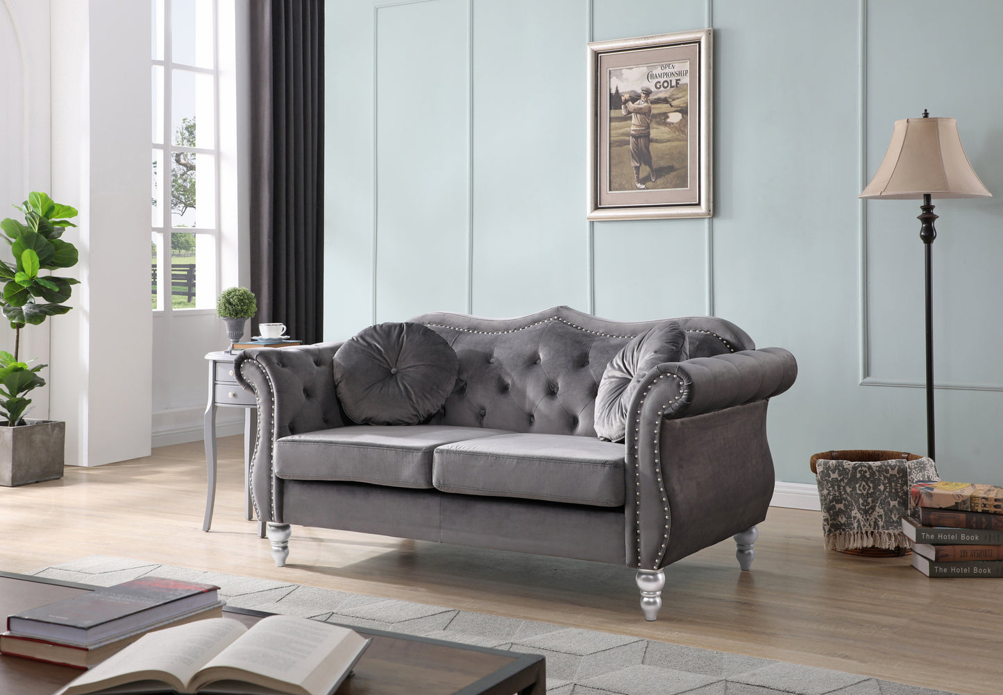 Tufted grey velvet loveseat with silver nailhead trim and ornate legs