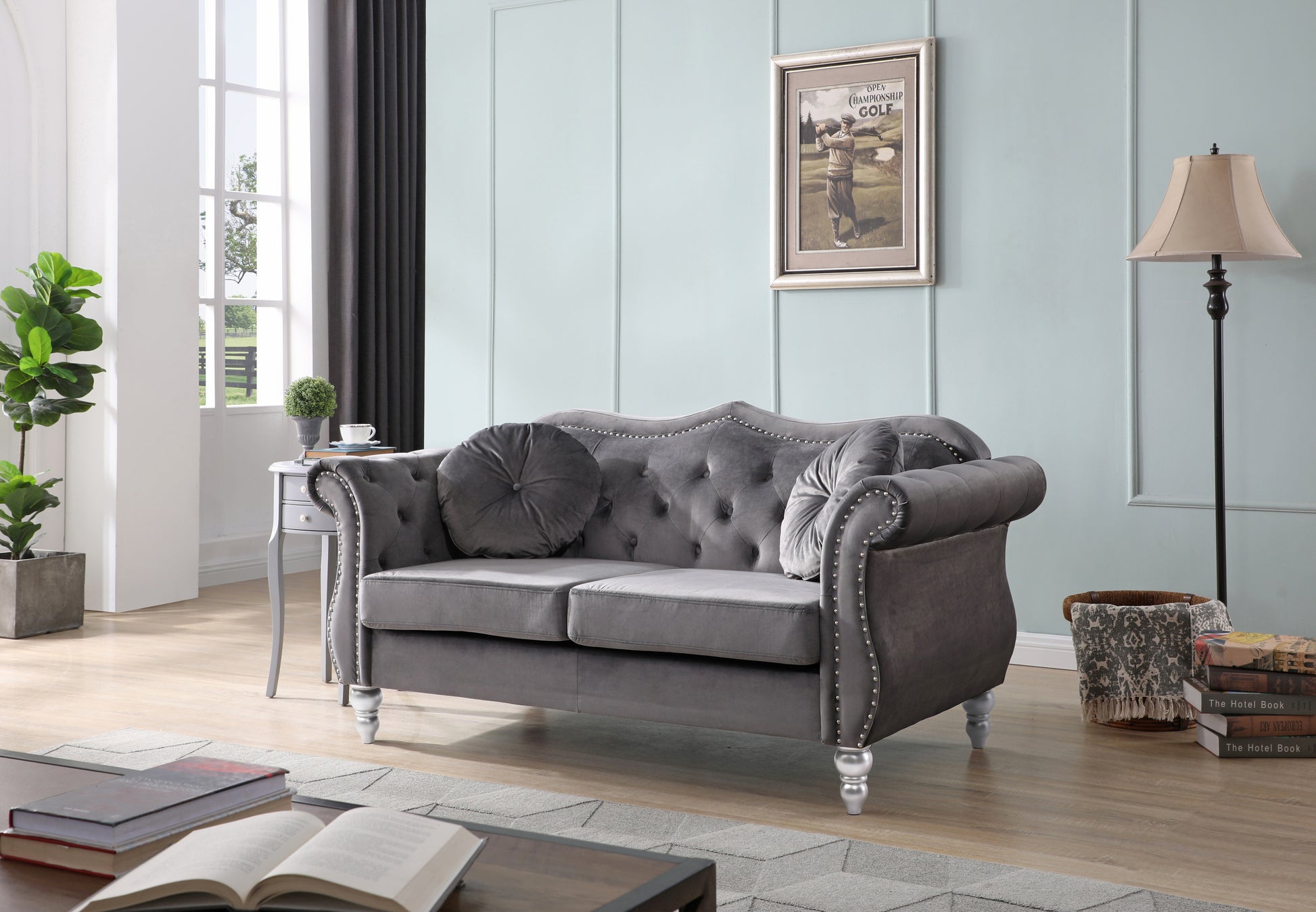 Tufted grey velvet loveseat with silver nailhead trim and ornate legs