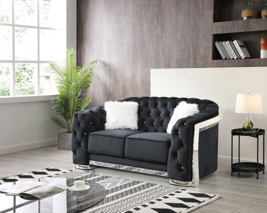 Tufted black velvet loveseat with crystal buttons and silver trim featuring plush white throw pillows