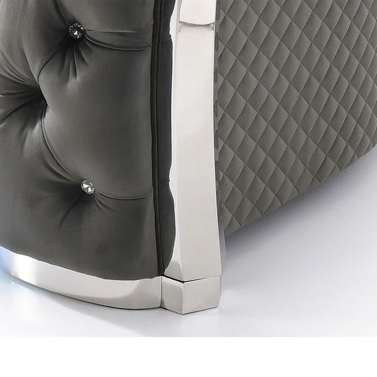 Dark gray tufted velvet sofa with diamond stitching and chrome accents