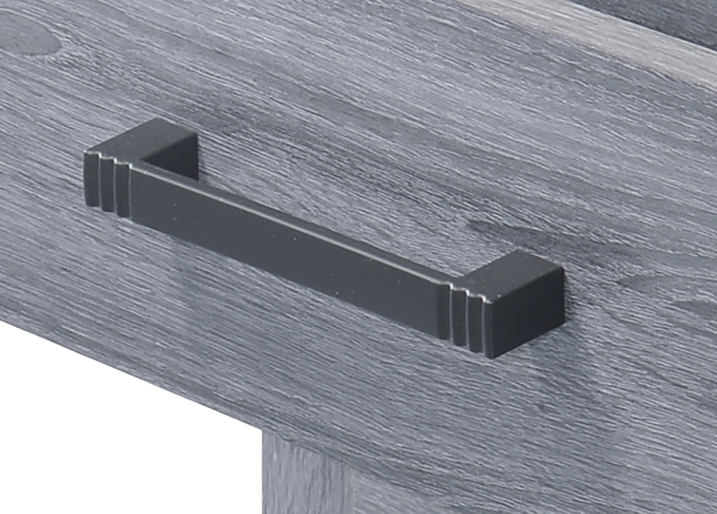 Modern black drawer pull with grooved accents on a grey wood grain surface