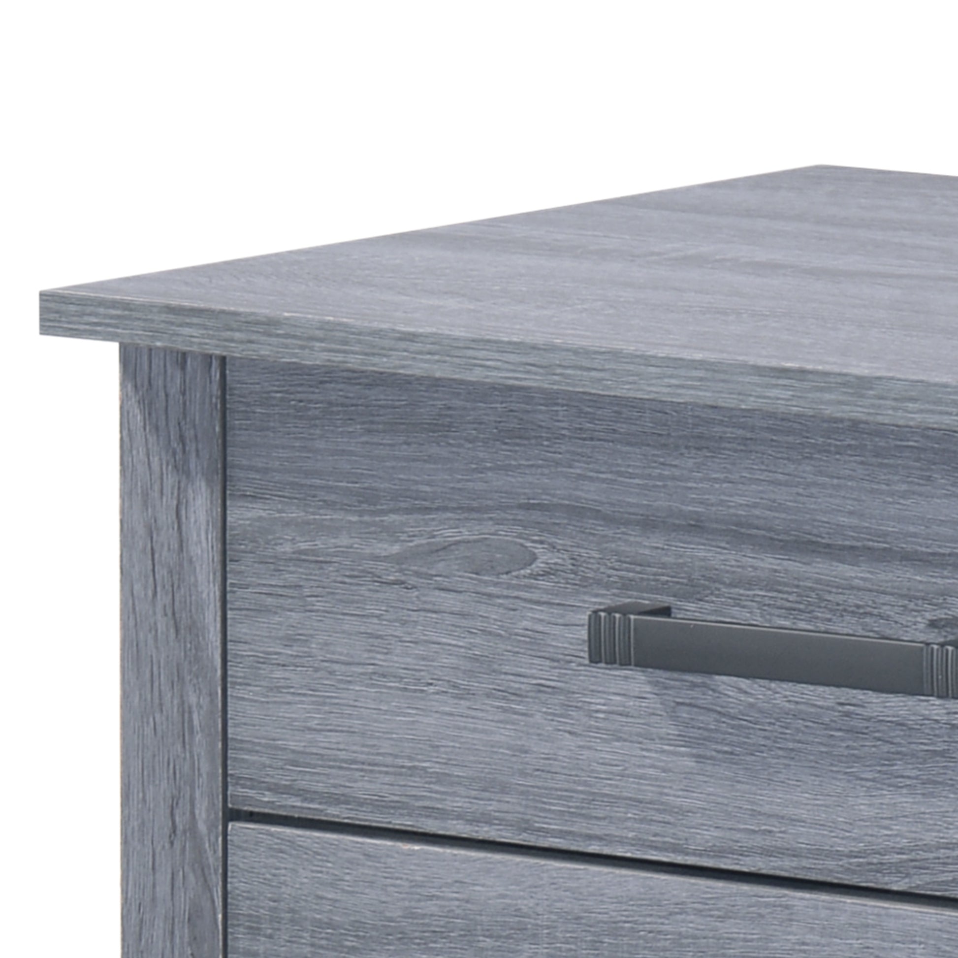 Closeup of a gray distressed wood dresser with a dark metal handle
