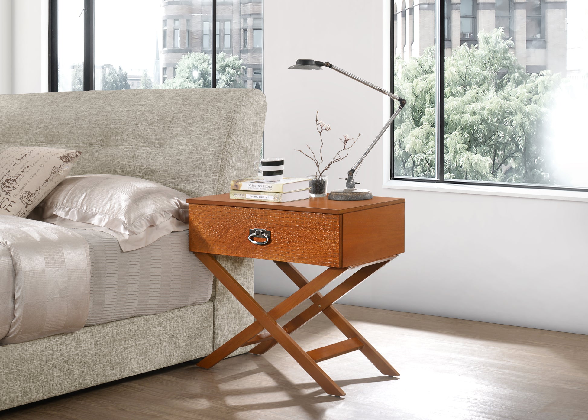 Midcentury modern wood bedside table with a textured drawer front and crisscross legs