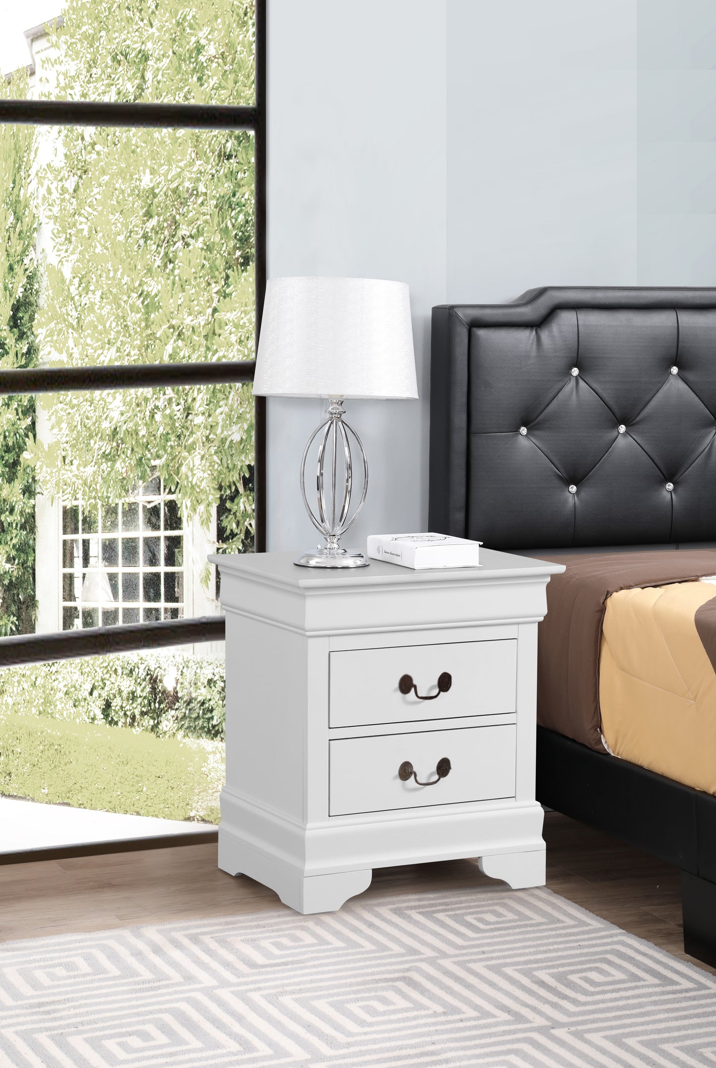 White twodrawer nightstand with ornate metal drawer pulls beside a bed