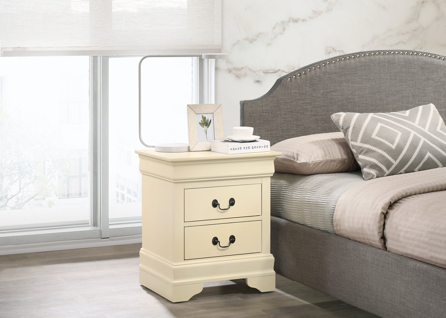 Cream bedside table with two drawers and ornate black handles