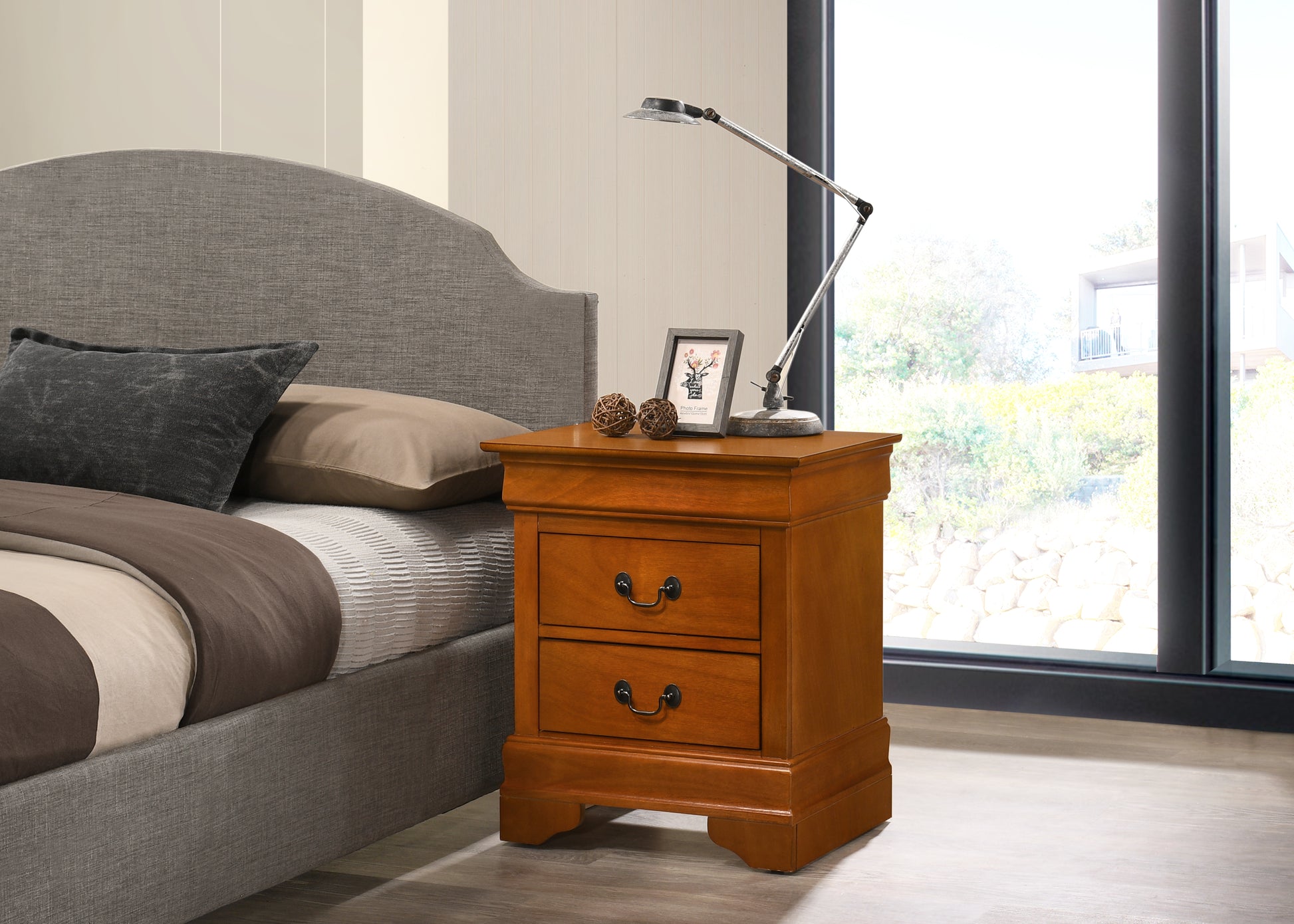 Warm oak bedside table with two drawers and ornate hardware
