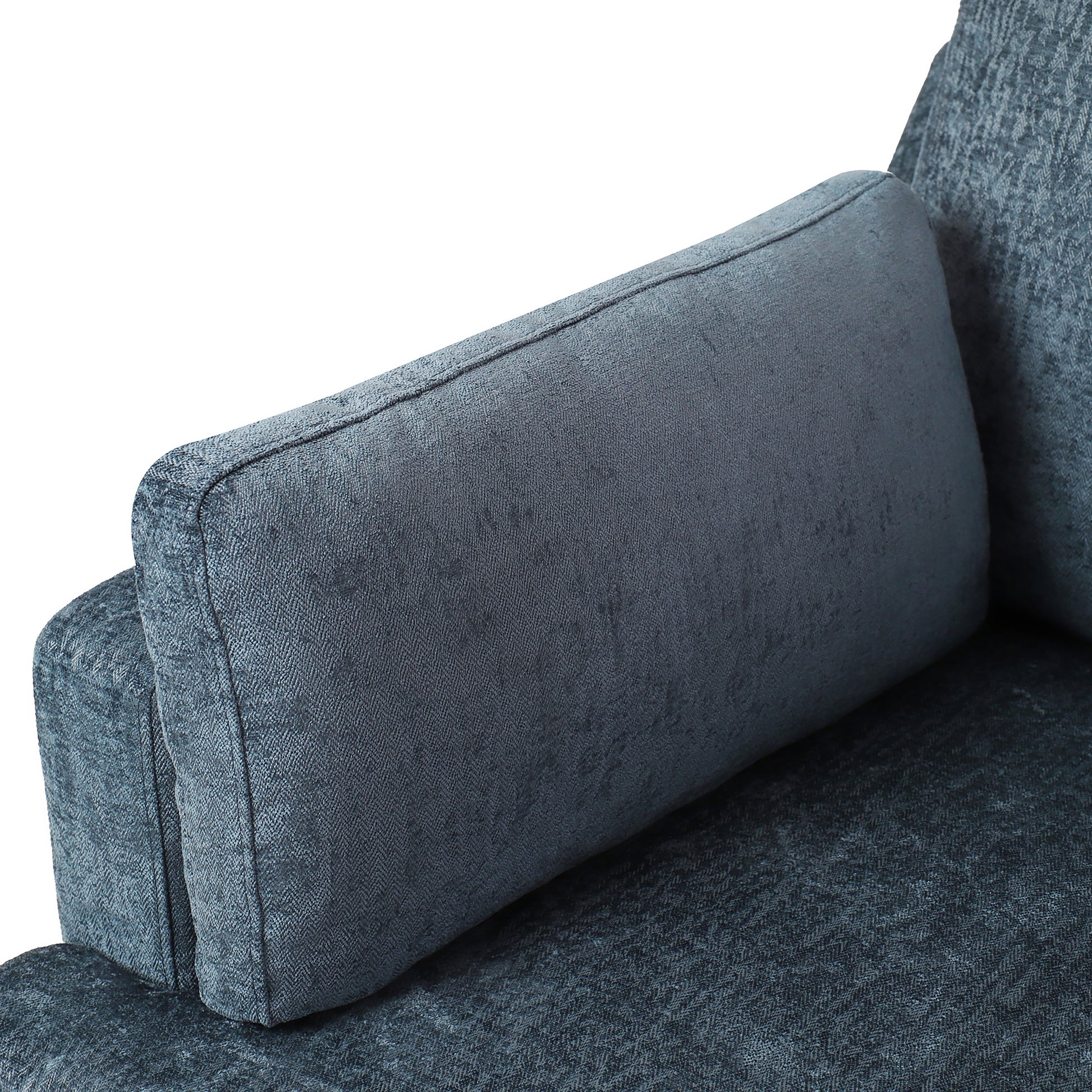 Closeup of a textured deep blue sofa cushion with stitched detailing