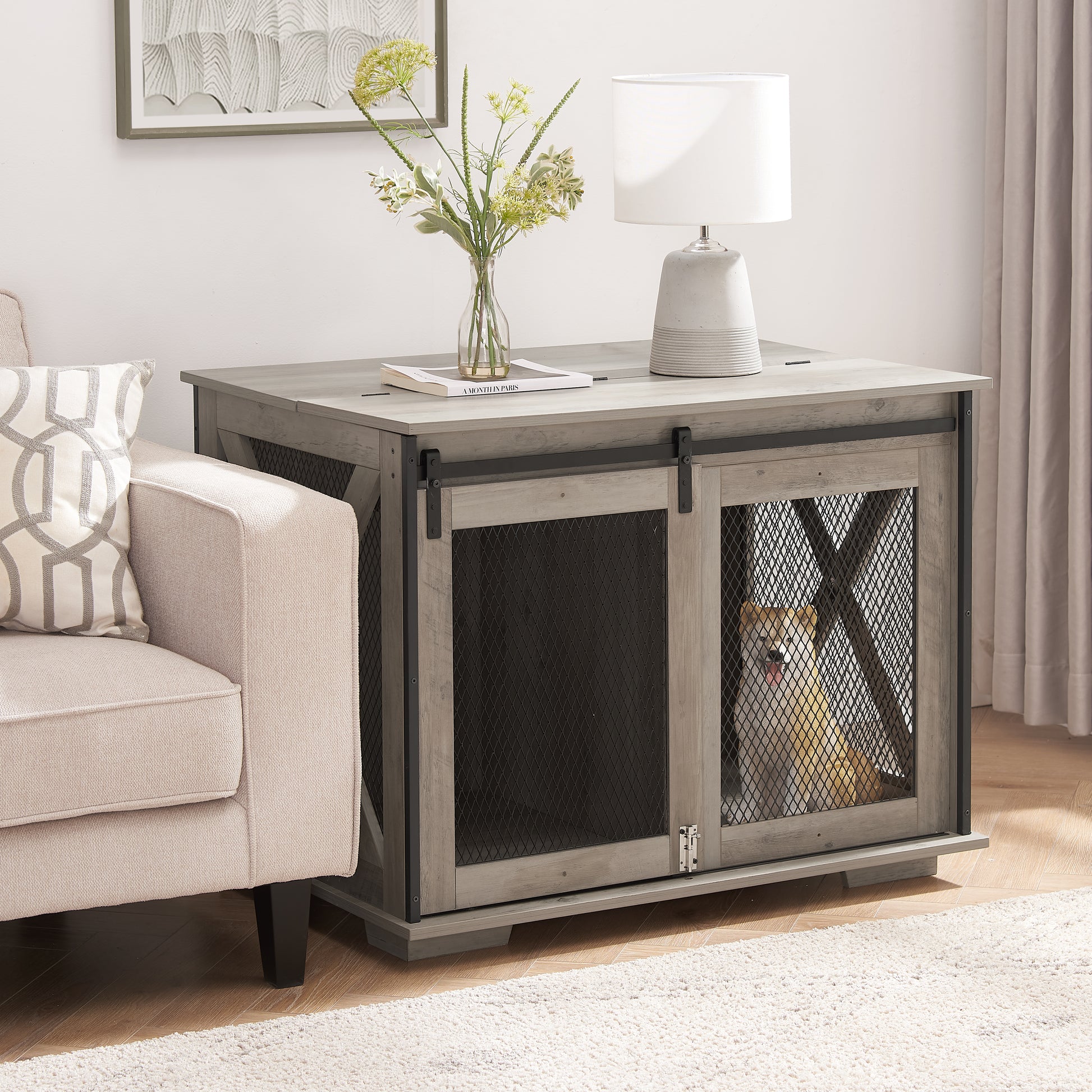 Rustic gray wooden dog crate with sliding barn door and mesh panel featuring a small dog inside