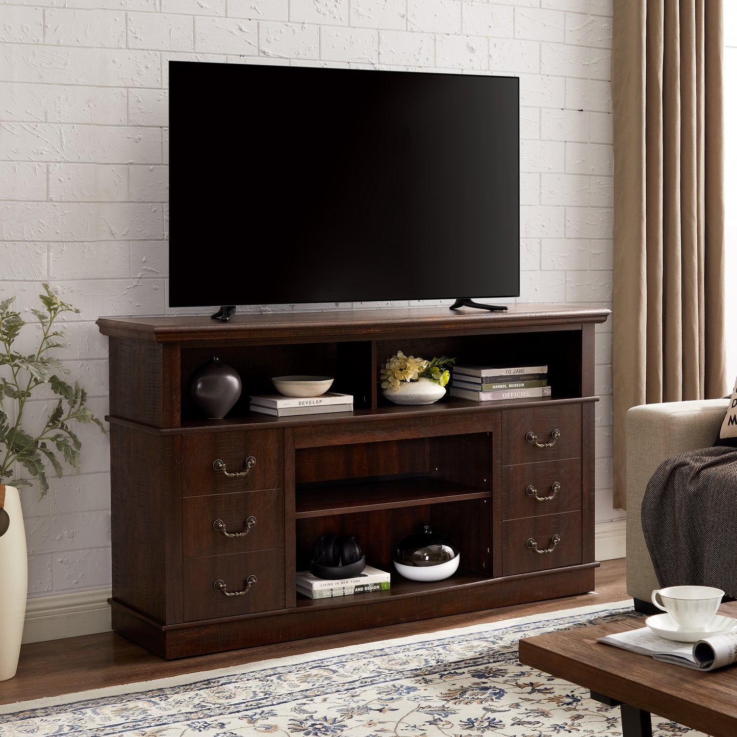 Dark wood TV stand with ornate brass hardware showcasing a modern living room setup