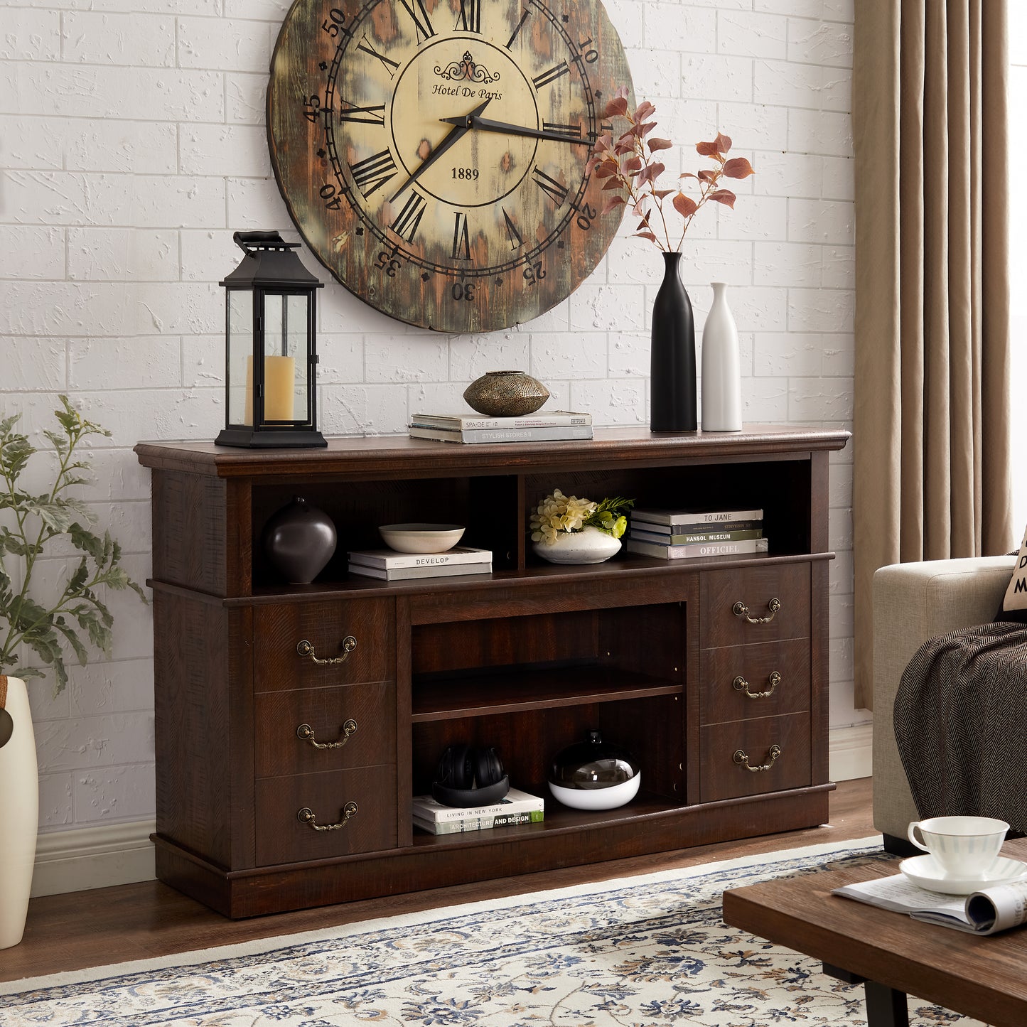 Dark wood TV stand with antique brass drawer pulls featuring open shelves and drawers for media storage