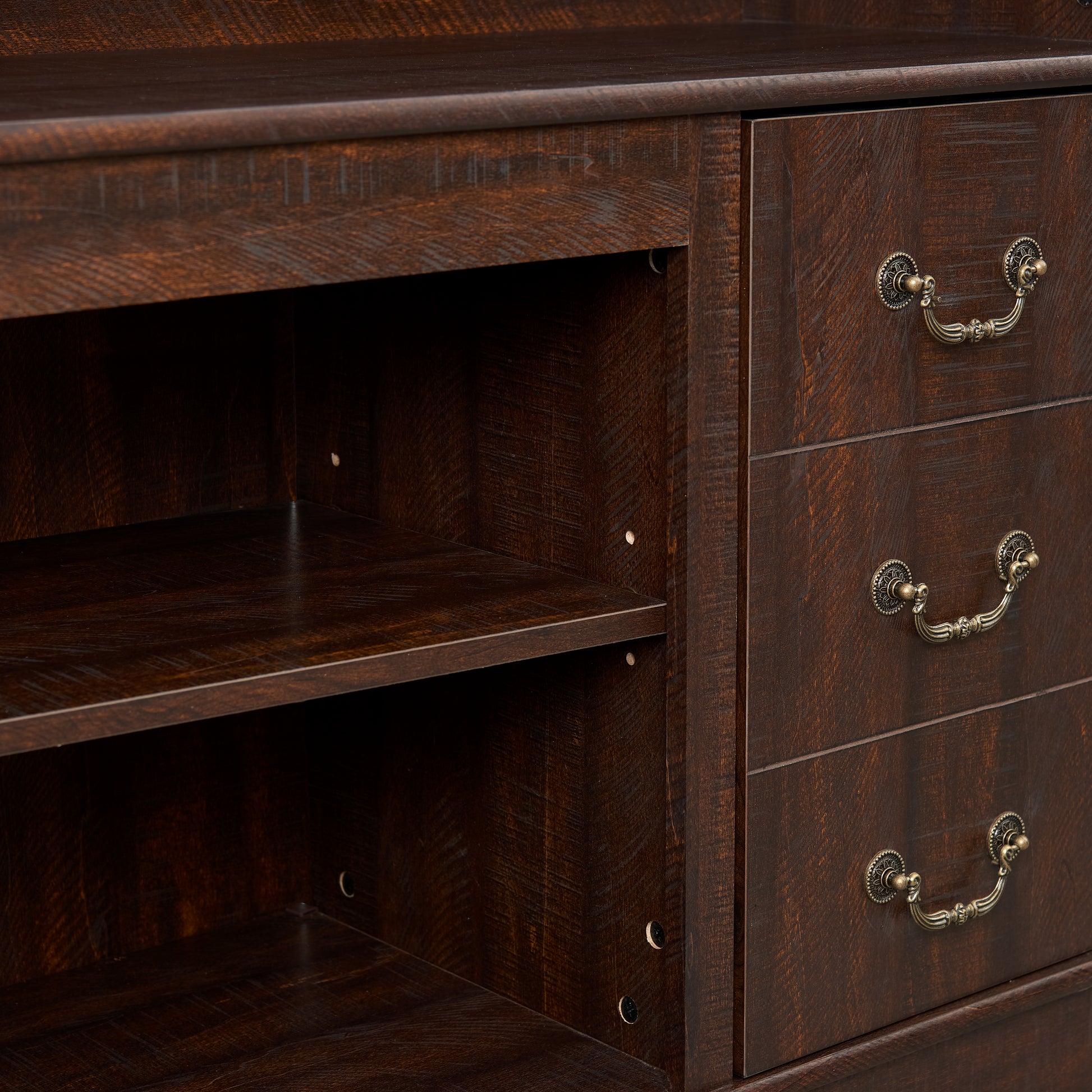 Dark wood dresser with three ornate brass drawer pulls and open shelving