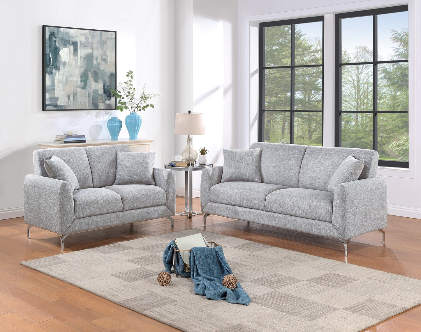 Gray fabric loveseat with modern chrome legs and throw pillows