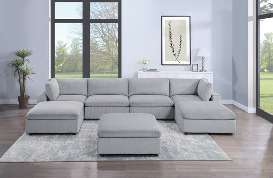Gray corduroy sectional sofa with chaise and ottoman for a modern living room