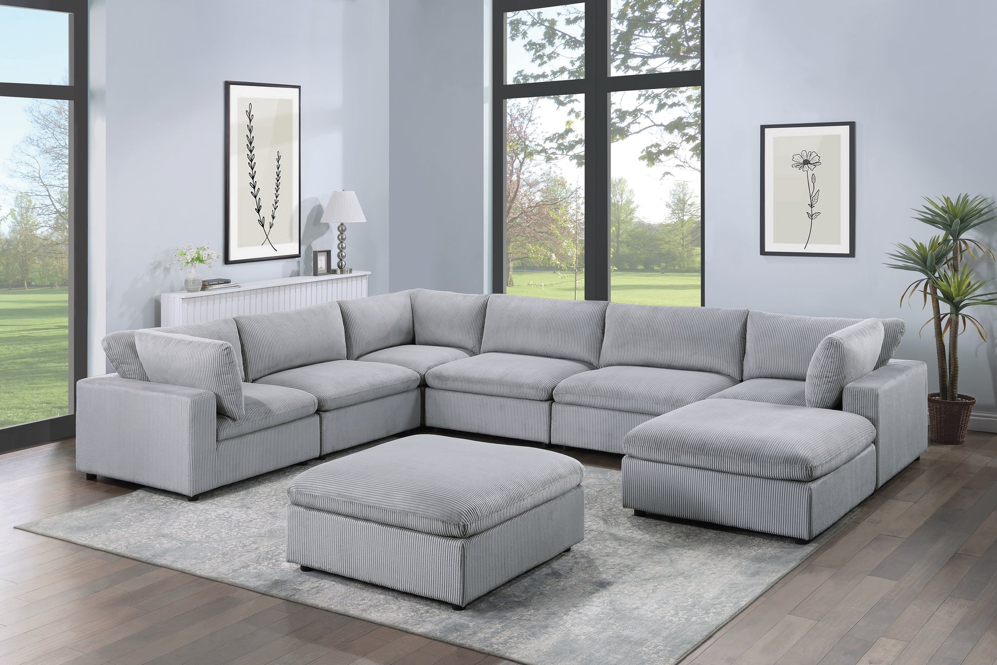 Light grey corduroy sectional sofa with matching ottoman on a patterned rug