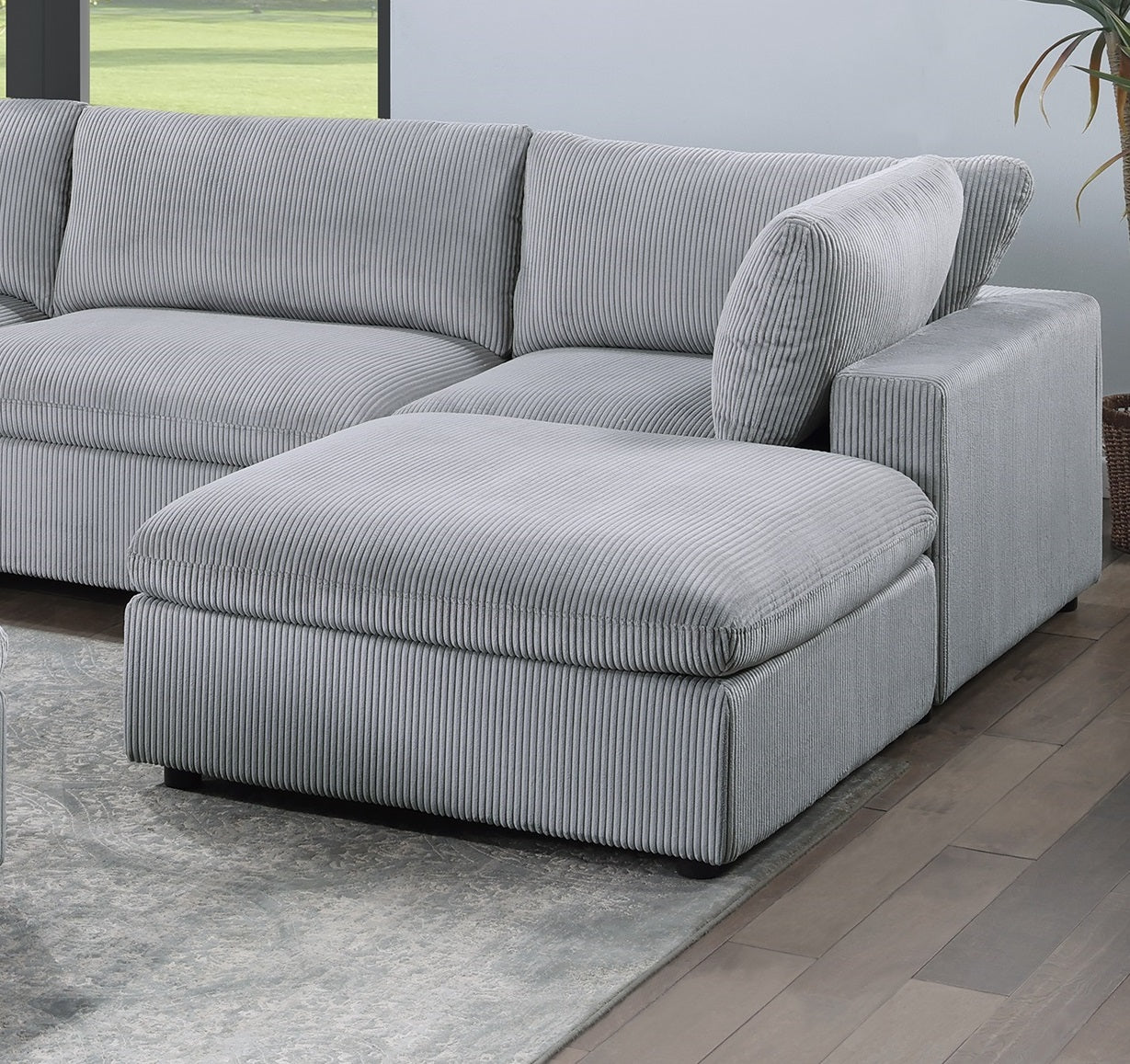 Plush grey corduroy sectional sofa with a chaise lounge attachment for ultimate comfort
