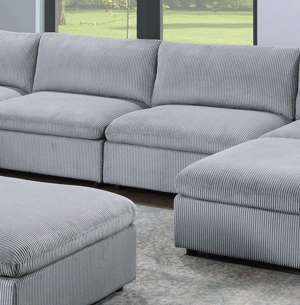 Sectional grey corduroy sofa with plush cushions and matching ottoman