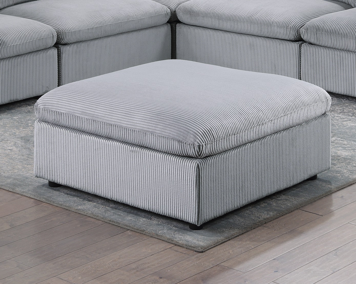 Plush grey corduroy square ottoman with matching sectional sofa