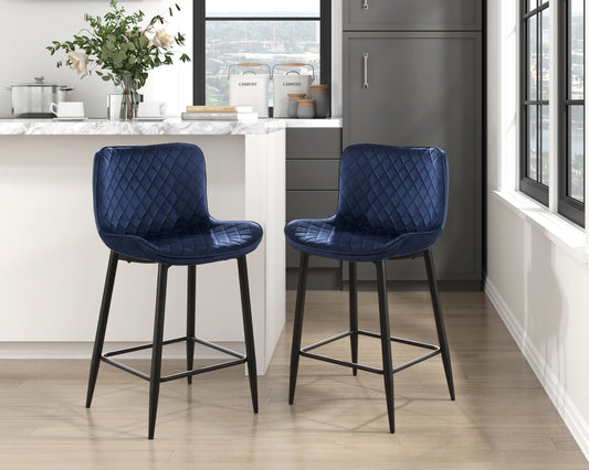 Two navy blue velvet bar stools with diamond tufting and black metal legs perfect for a modern kitchen island