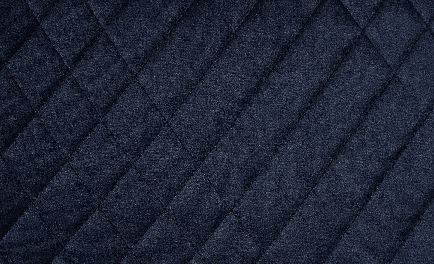 Dark navy quilted fabric texture with diamond stitching