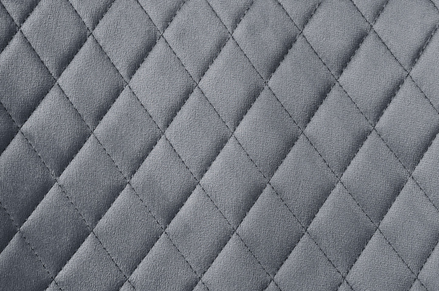 Closeup of gray quilted fabric texture with diamond pattern stitching