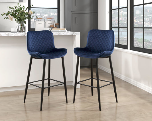 Pair of plush navy blue velvet bar stools with diamond tufting and black metal legs