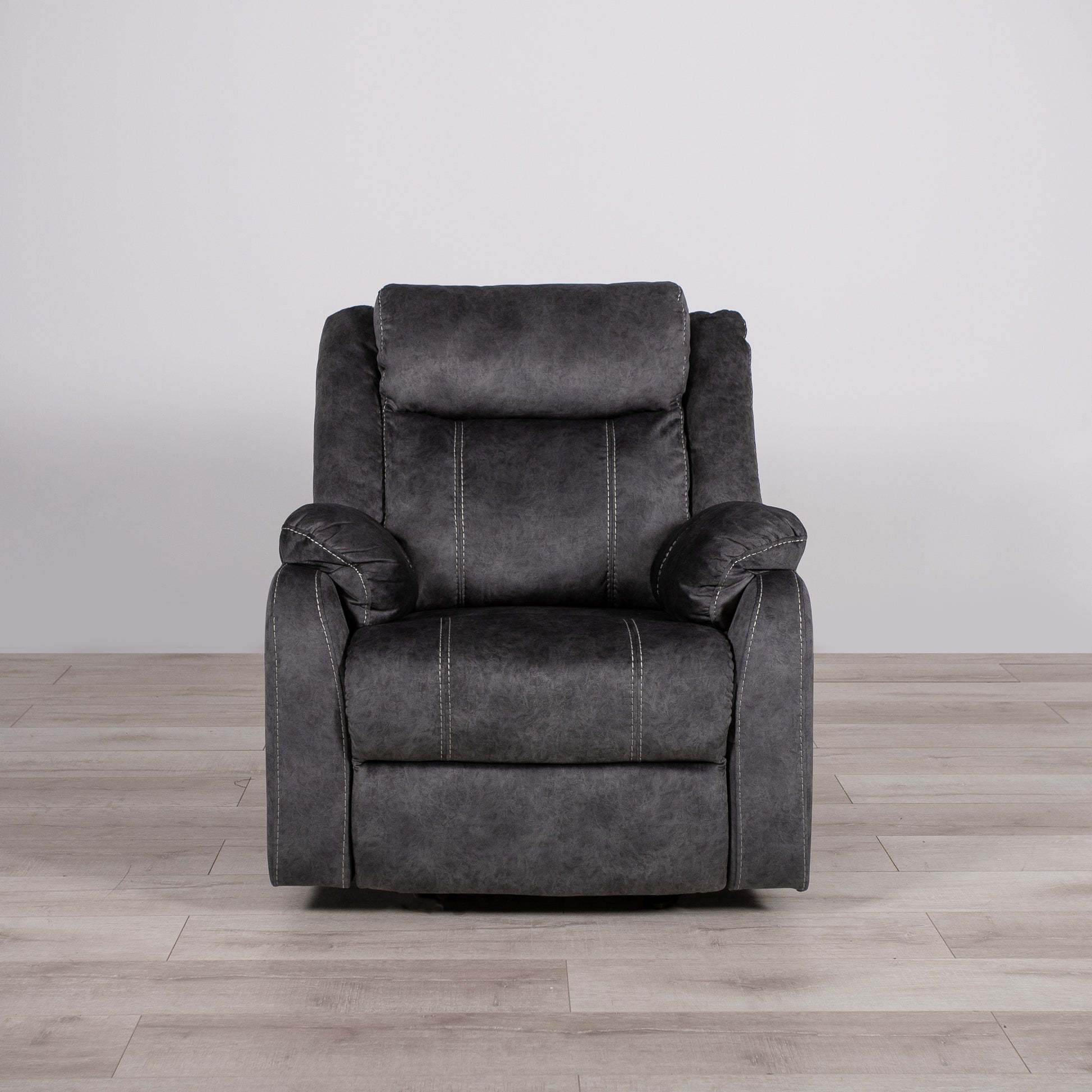 Comfortable charcoal grey recliner chair with white stitching detail and padded headrest