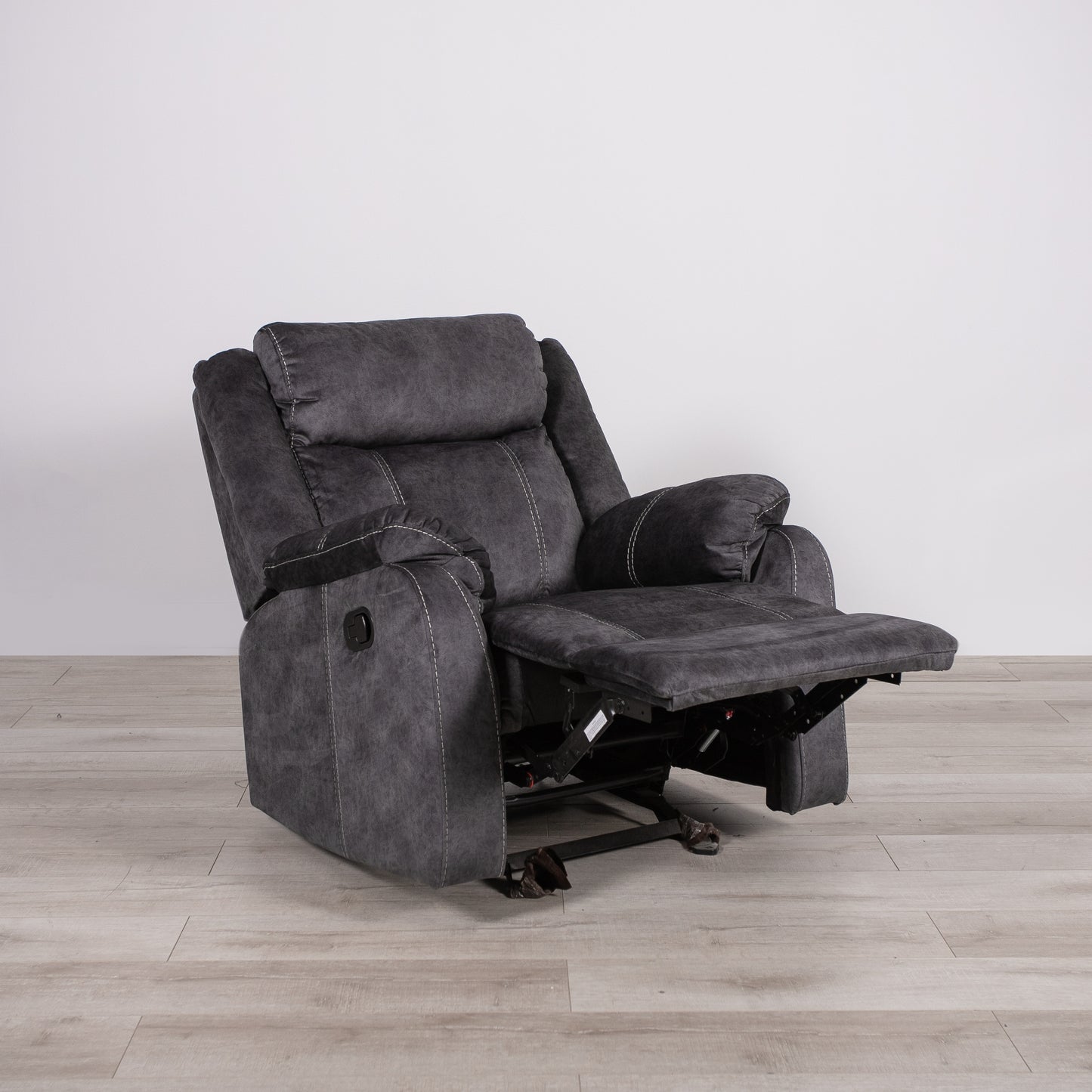 Dark gray fabric recliner chair with white stitching and adjustable footrest perfect for home