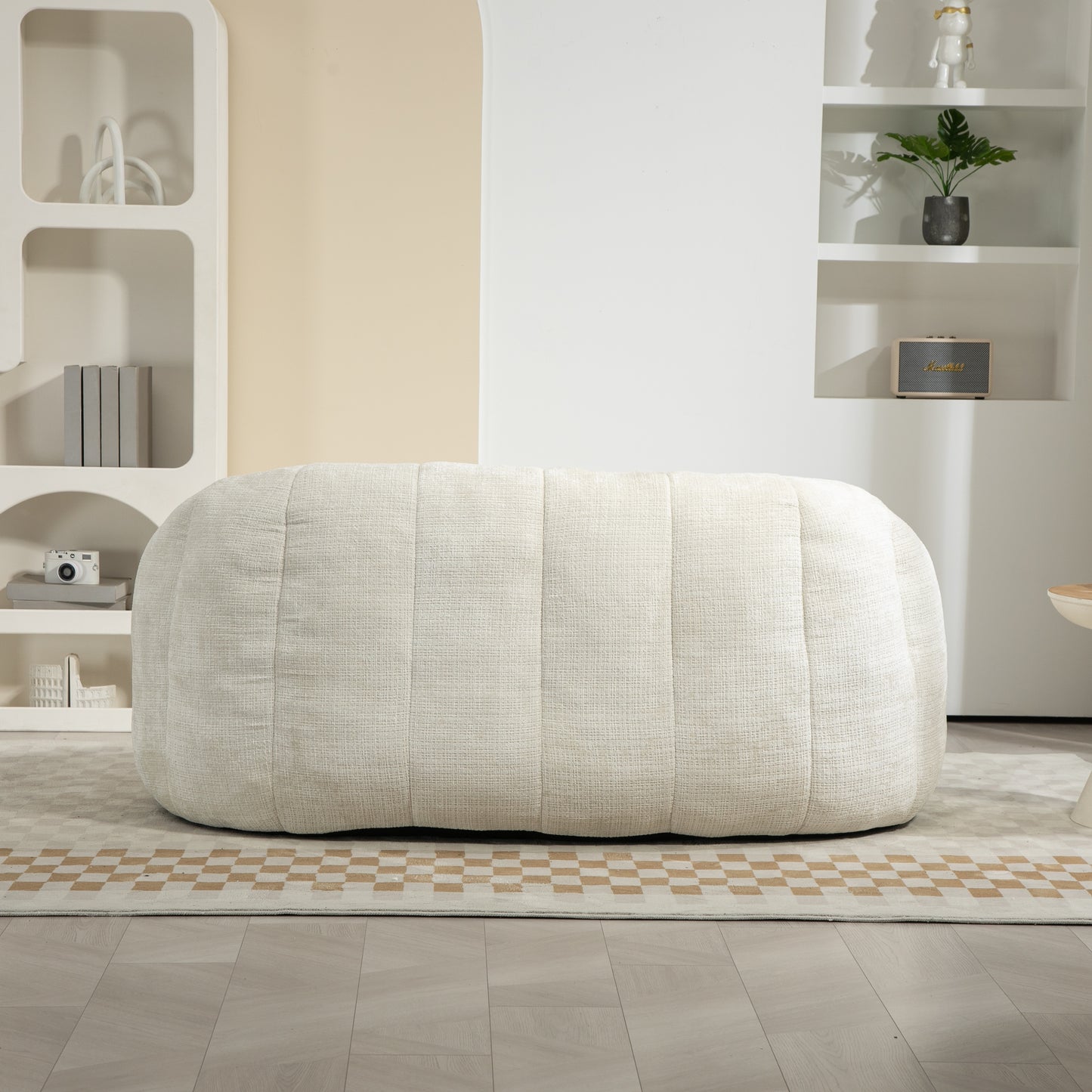 Cream textured upholstered ottoman with vertical stitching modern living room decor