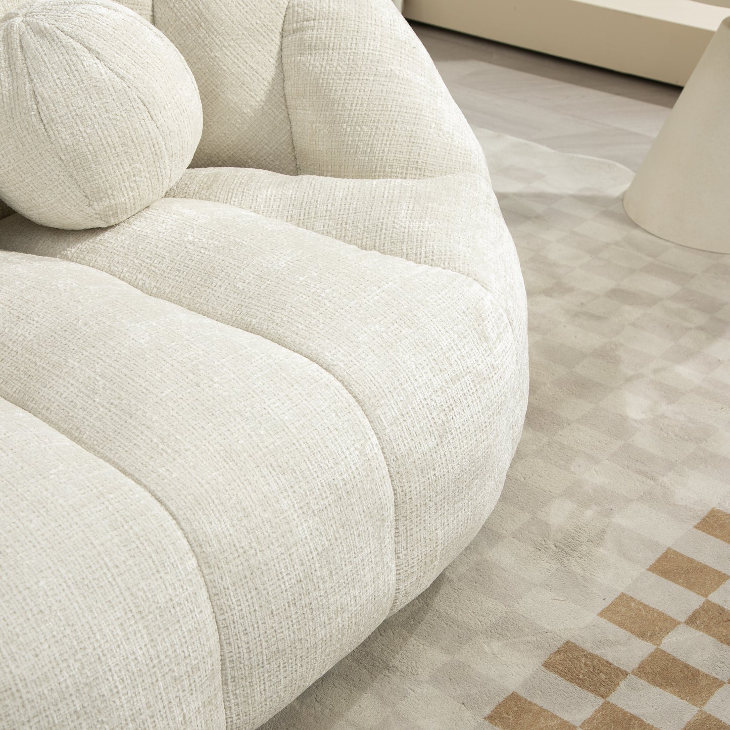 Plush ivory boucle armchair with rounded design and textured fabric upholstery