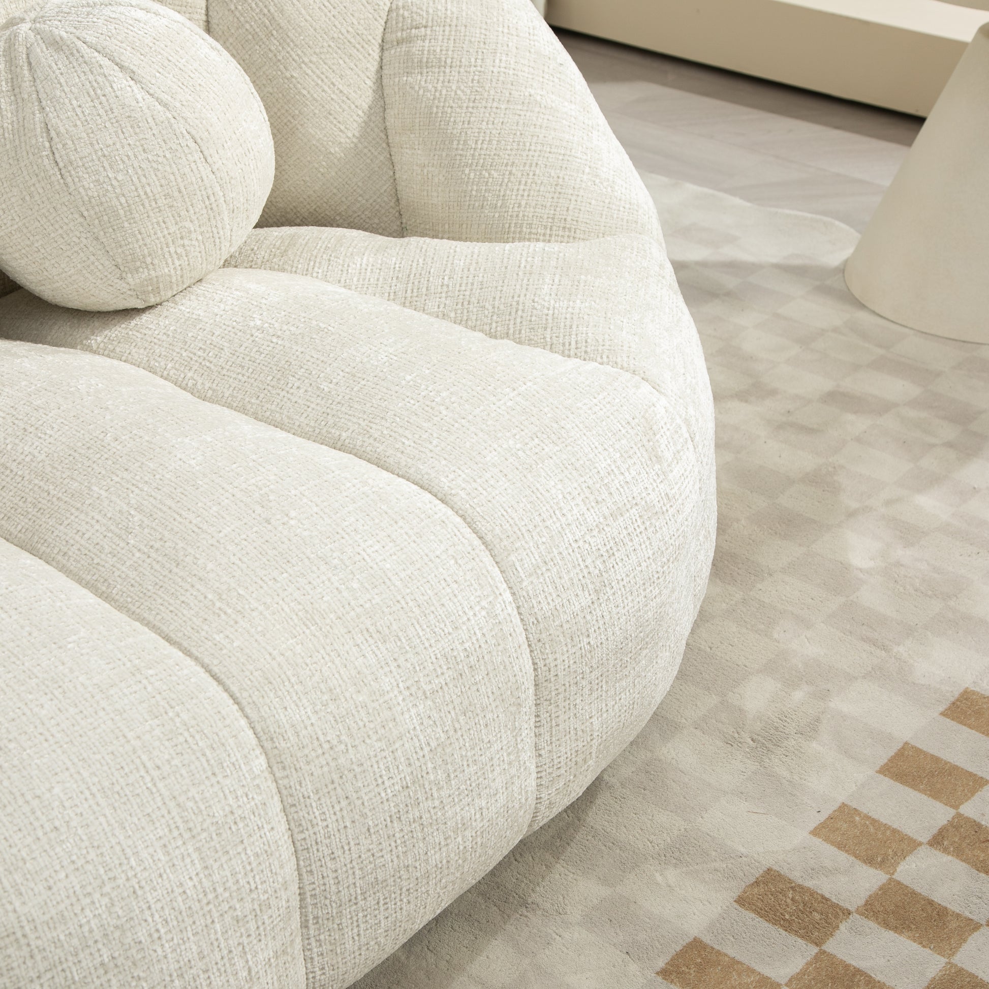 Plush ivory boucle armchair with rounded design and textured fabric upholstery