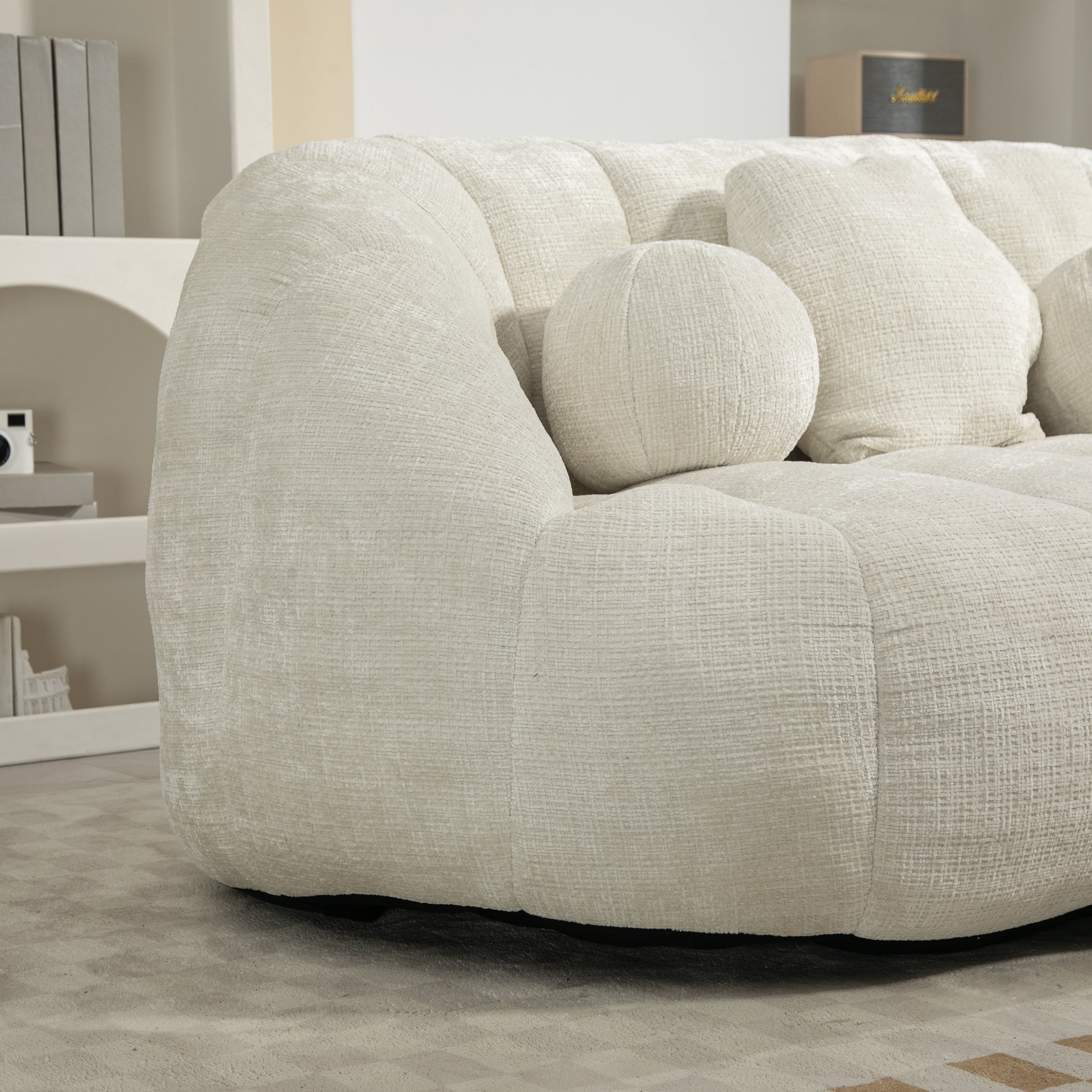 Cream boucle tufted sofa with round accent pillow for living room comfort