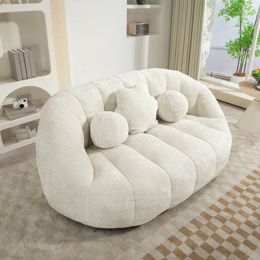 Plush cream boucle sofa with channel tufting and round accent pillows for a modern living room